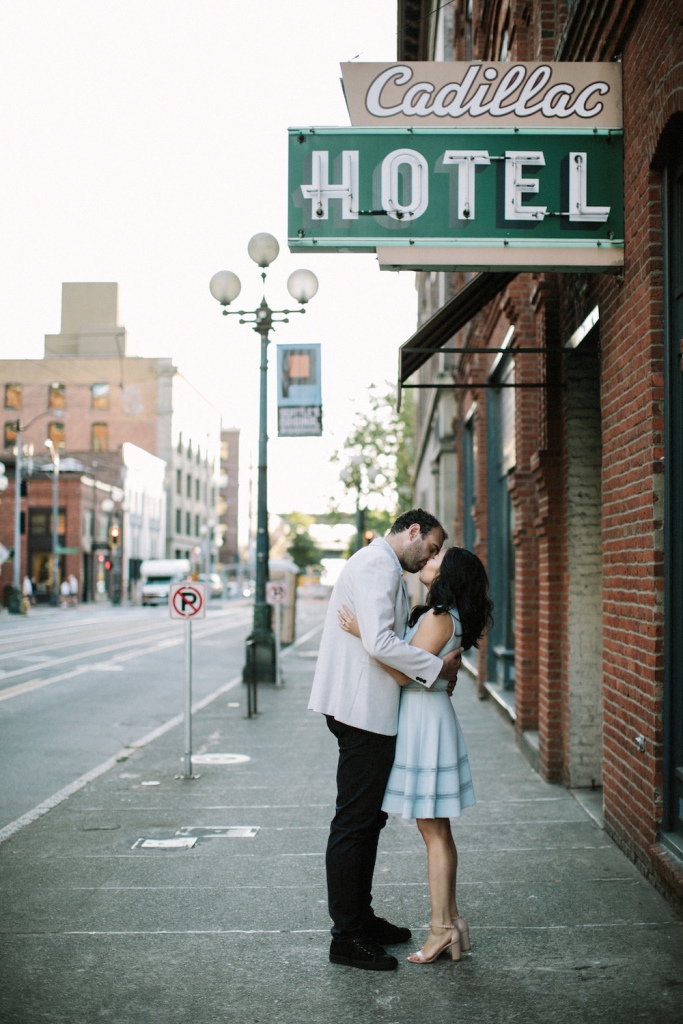 engaged couple kissing at pioneer square in seattle
