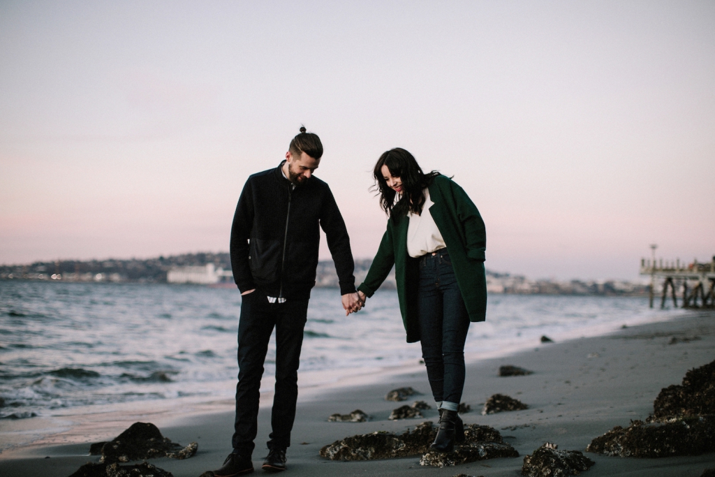 couple holding hands at luna park in seattle