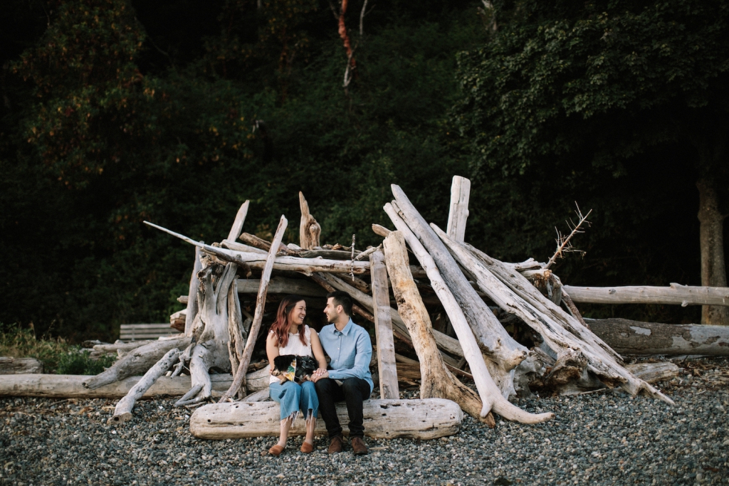 couple staring at each other while sitting at lincoln park in seattle