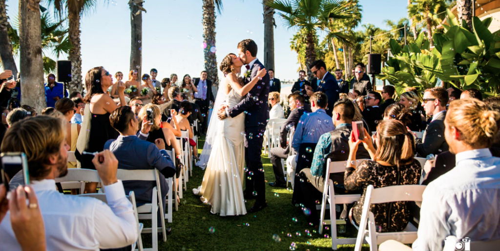 couple kissing after exchanging their vows at an outdoor wedding ceremony at paradise point resort & spa