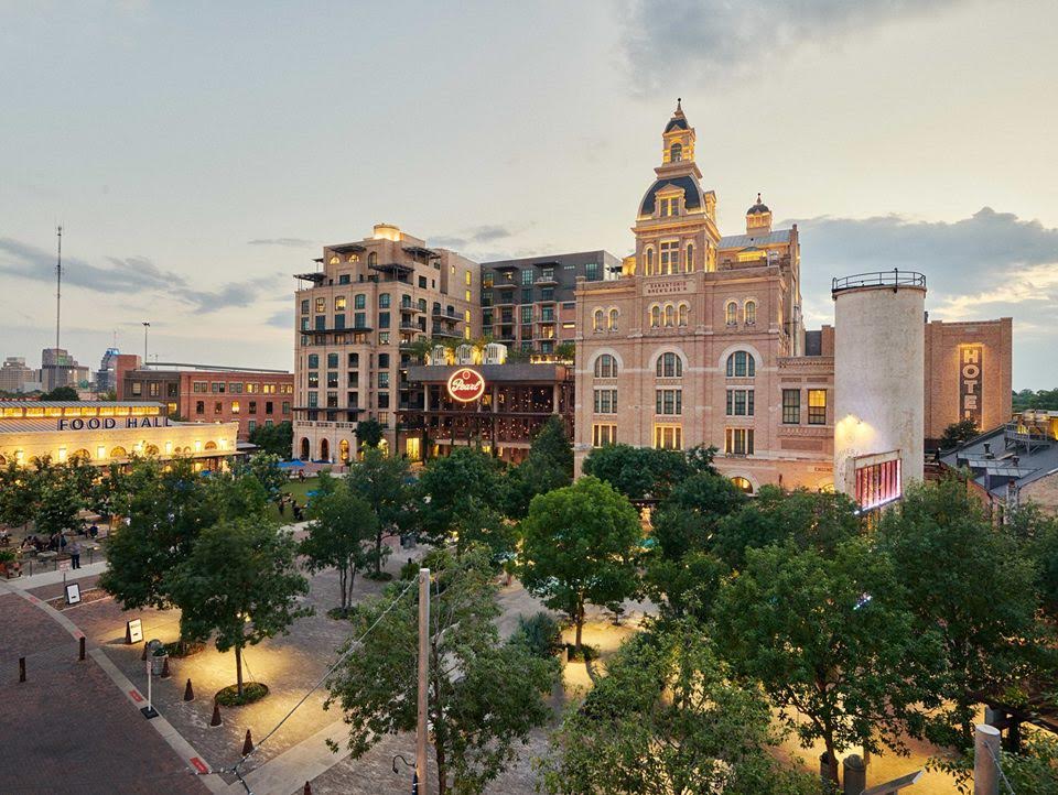 the brick and stone exterior of the Historic Pearl in San Antonio, Texas at sunset