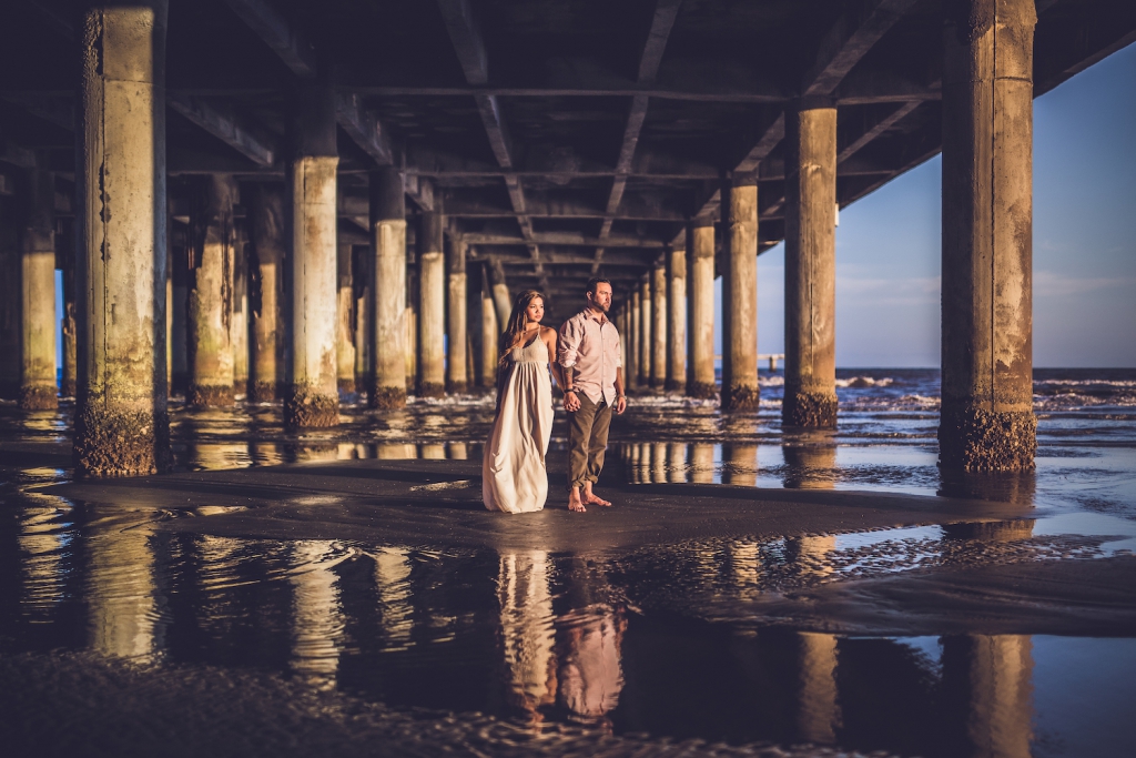 man and woman hold hands at pleasure pier near galveston in houston