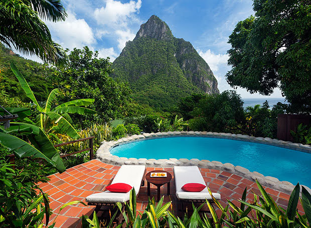 two white lounge chairs by a private pool looking out on Petit Piton at a villa at Stonefield Estate Resort in St. Lucia