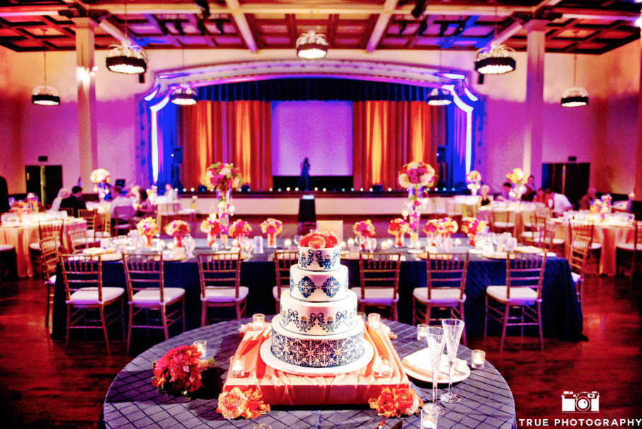 wedding cake and table settings in the grand ballroom at the prado at balboa park