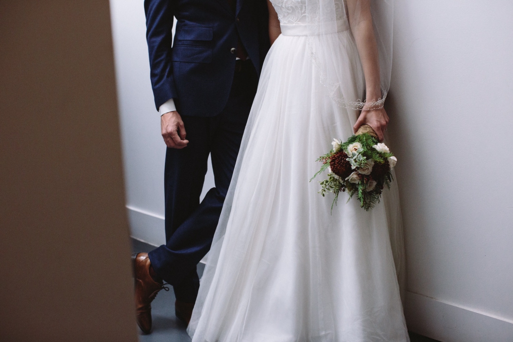 bride holding bouquet next to groom