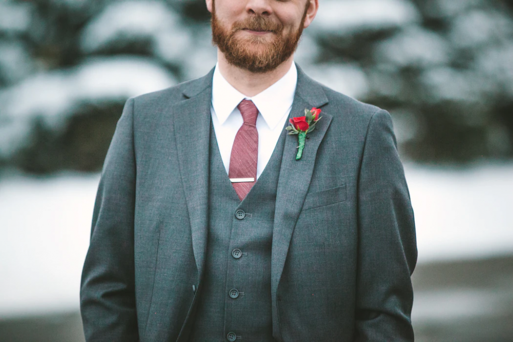Groomsman with red rose on lapel