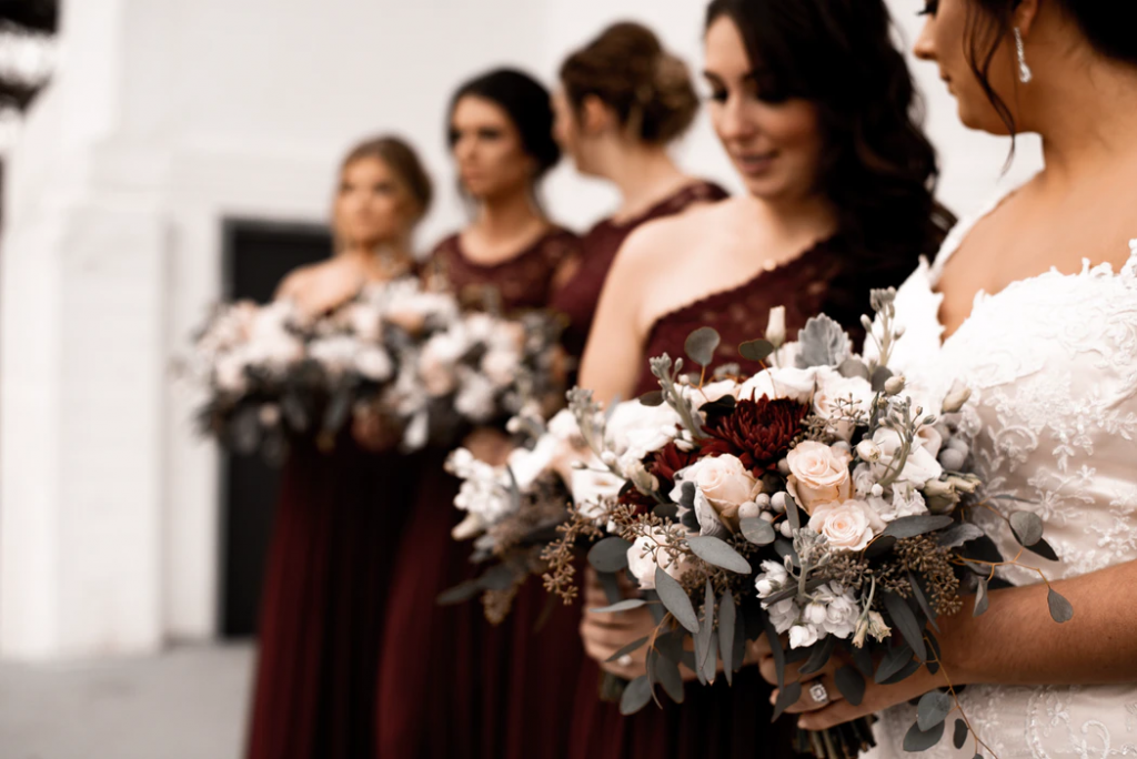 Bridal party in deep berry hues make for beautiful winter wedding colors