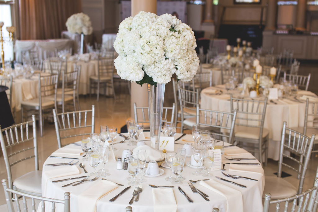 Wedding reception decor in white and metallic accents