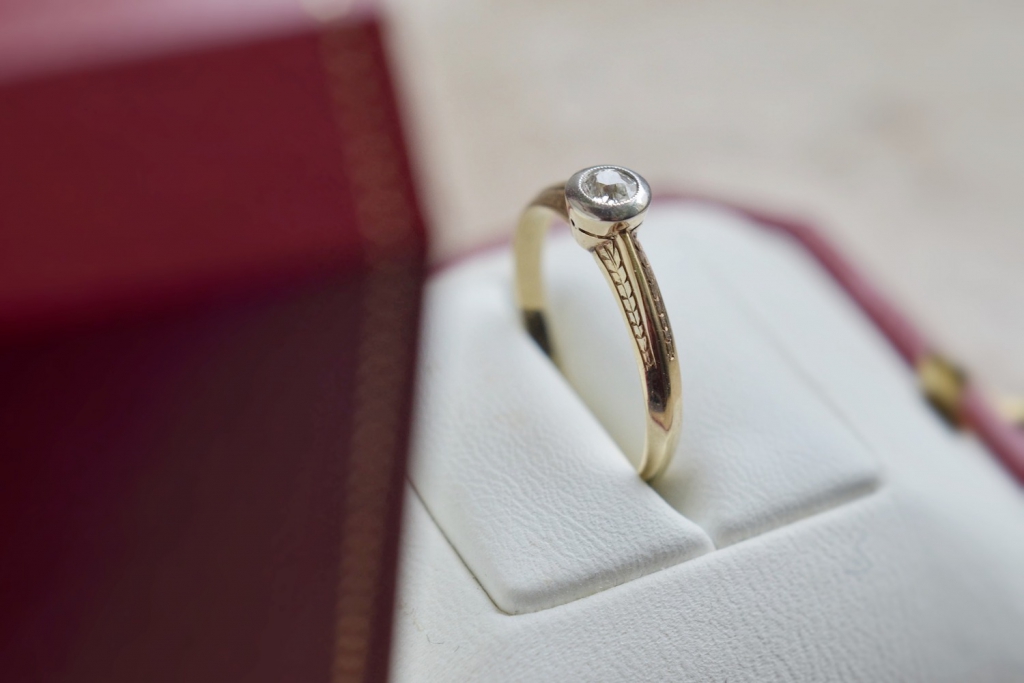 gold engagement ring in red box